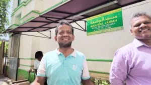 Dua orang pria Muslim Sri Lanka tersenyum ramah di depan bangunan masjid